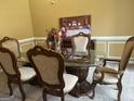 Formal dining room with a glass-top table and six chairs at 1221 Rhodes Sw Walk, Conyers, GA 30094