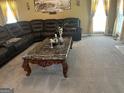 Living room with a sectional sofa and large coffee table at 1221 Rhodes Sw Walk, Conyers, GA 30094