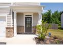 Dark brown front door with glass panels and brick accents at 6904 Oak Valley Dr, Douglasville, GA 30134