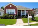 Brick ranch home with front porch and American flag at 110 Emily Park, Fayetteville, GA 30215