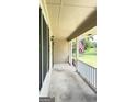 Covered porch with white railing and American flag at 192 Wedgefield Dr, Mcdonough, GA 30252