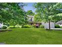 Landscaped front yard with large trees and spacious lawn at 3463 Madison Farm Way, Snellville, GA 30039