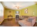 Living room with green walls, fireplace, and sectional sofa at 445 Brickstone Way, Covington, GA 30016