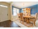 Formal dining room with hardwood floors and a chandelier at 445 Brickstone Way, Covington, GA 30016