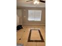 Living room with tiled floor and large window at 449 Kara Ln, Mcdonough, GA 30253