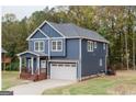 Two-story home with blue siding, white trim, and a brown porch at 413 Winterwood, Stockbridge, GA 30281