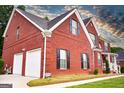 Brick house with a two car garage and nicely manicured lawn at 132 Sunflower Meadows Dr, Mcdonough, GA 30252