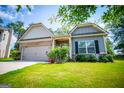 Charming ranch home with gray siding, brick accents, and a well-manicured lawn at 442 River Bluff Dr, Temple, GA 30179