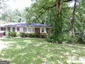 Brick ranch house nestled in a wooded area at 2093 Wildrose Dr, Decatur, GA 30032
