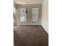Spacious dining room featuring a chandelier and neutral decor at 7495 St David St, Fairburn, GA 30213