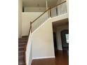 Elegant staircase with wooden railings and neutral walls at 7495 St David St, Fairburn, GA 30213