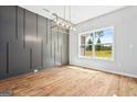 Bright dining room with large window and modern chandelier at 114 Corinth Reserve Pl # 8, Grantville, GA 30220