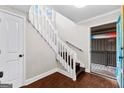 Bright entryway with staircase, wood floors, and access to exterior deck at 12 Fairway Ln, Peachtree City, GA 30269