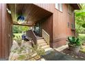 Exterior entrance with wooden stairs and golf cart at 12 Fairway Ln, Peachtree City, GA 30269
