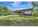 Ranch home with stone accents and a covered porch at 2752 Poplar Rd, Sharpsburg, GA 30277