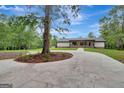 Ranch home with circular driveway and mature trees at 2752 Poplar Rd, Sharpsburg, GA 30277