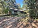 Ranch-style home situated on a wooded lot at 1569 King Mill Rd, Mcdonough, GA 30252