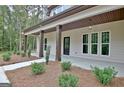 Inviting front porch with wooden posts and landscaping at 406 Lowery Rd, Grantville, GA 30220