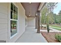 Covered side porch offering outdoor space at 406 Lowery Rd, Grantville, GA 30220