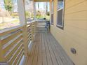 Wooden front porch with railing and seating at 321 Seventh Ave, Scottdale, GA 30079