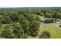 Aerial view showing home, large lot, and surrounding trees at 1072 Harbins Rd, Dacula, GA 30019