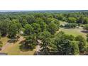 Aerial view of property with home nestled amongst trees at 1072 Harbins Rd, Dacula, GA 30019