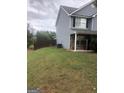 Side view of two-story house with gray siding and fenced yard at 25 Franklin Way, Covington, GA 30016