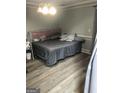Primary bedroom with gray walls, wood-look flooring, and a king-size bed at 25 Franklin Way, Covington, GA 30016
