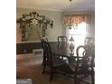 Formal dining room with chandelier and painted accent wall at 1145 Lake Stone Lea Dr, Oxford, GA 30054
