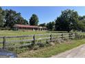 Brick ranch house with red roof, situated on a large lot at 175 Moss Dr, Mcdonough, GA 30252