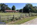 Brick ranch house with red roof, situated on a large lot at 175 Moss Dr, Mcdonough, GA 30252