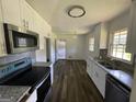 Renovated kitchen with white cabinets, granite counters, and stainless steel appliances at 2101 Ann Se Ct, Conyers, GA 30013
