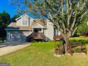 House with a well and a wooden bench in the front yard at 359 Scenic Ln, Auburn, GA 30011