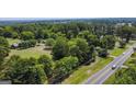 Aerial view of property showing home, detached garage, and expansive green space at 1112 Harbins Rd, Dacula, GA 30019