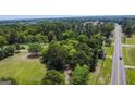 Aerial view of property near a road and trees at 1112 Harbins Rd, Dacula, GA 30019