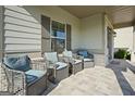 Relaxing front porch with wicker chairs at 125 Leverett Ct, Fayetteville, GA 30215