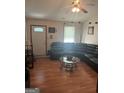 Living room with sectional sofa, coffee table, and hardwood floors at 243 Lakeview Dr, Stockbridge, GA 30281