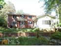 Two-story home with brick and siding exterior at 573 Lester Rd, Fayetteville, GA 30215
