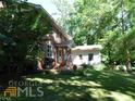 Brick home with a detached building and patio at 573 Lester Rd, Fayetteville, GA 30215