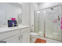 Clean bathroom with a shower, white cabinets, and modern fixtures at 3290 Stock Saddle Pl, Cumming, GA 30040