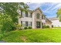 Two-story house with stone accents, double garage, and landscaped lawn at 1125 Misty Meadows Ln, Hampton, GA 30228