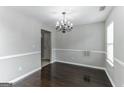 Bright dining room with dark hardwood floors and chandelier at 1125 Misty Meadows Ln, Hampton, GA 30228