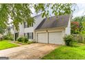 Two-story house with double garage and landscaping at 1125 Misty Meadows Ln, Hampton, GA 30228