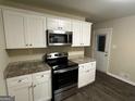 Renovated kitchen featuring white shaker cabinets, granite countertops, and stainless steel appliances at 3207 Cloverhurst Dr, East Point, GA 30344