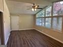 Bright living room with hardwood floors, large windows, and ceiling fan at 2213 Westover Dr, East Point, GA 30344
