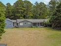 Gray house with large yard and wooded area, seen from above at 1142 Harbins Rd, Dacula, GA 30019