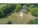Aerial view of a brick ranch house with a large yard at 825 S Bethany Rd, Locust Grove, GA 30248