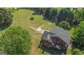 Aerial view of brick house with large backyard and trees at 825 S Bethany Rd, Locust Grove, GA 30248