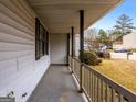 Covered porch with railing, overlooking the front yard at 602 Pine Tree Trl, College Park, GA 30349