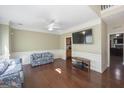 Living room with hardwood floors, floral couch, and large TV at 1231 Hillview Rd, Hampton, GA 30228